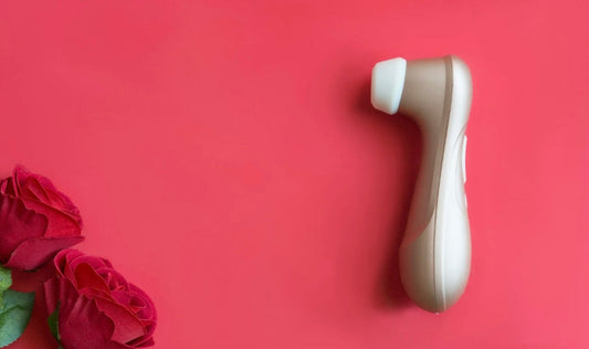 Forget dinner and a movie — turn date night into a pleasure ritual with these 3 sex toys for couples. Perfect for connection, foreplay, and unforgettable nights in. A sex toy on a red background with red roses in the corner