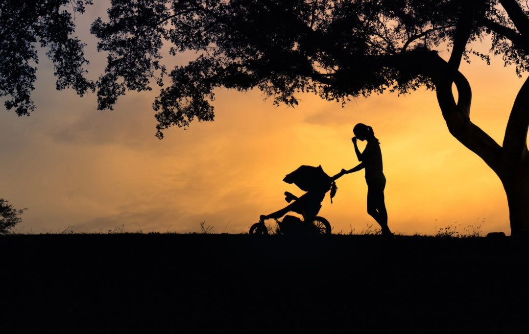The journey back to intimacy after birth can be tender, emotional, and complex. Here’s how to support your partner after birth — with empathy, patience, and genuine connection. a woman pushing a buggy a dusk